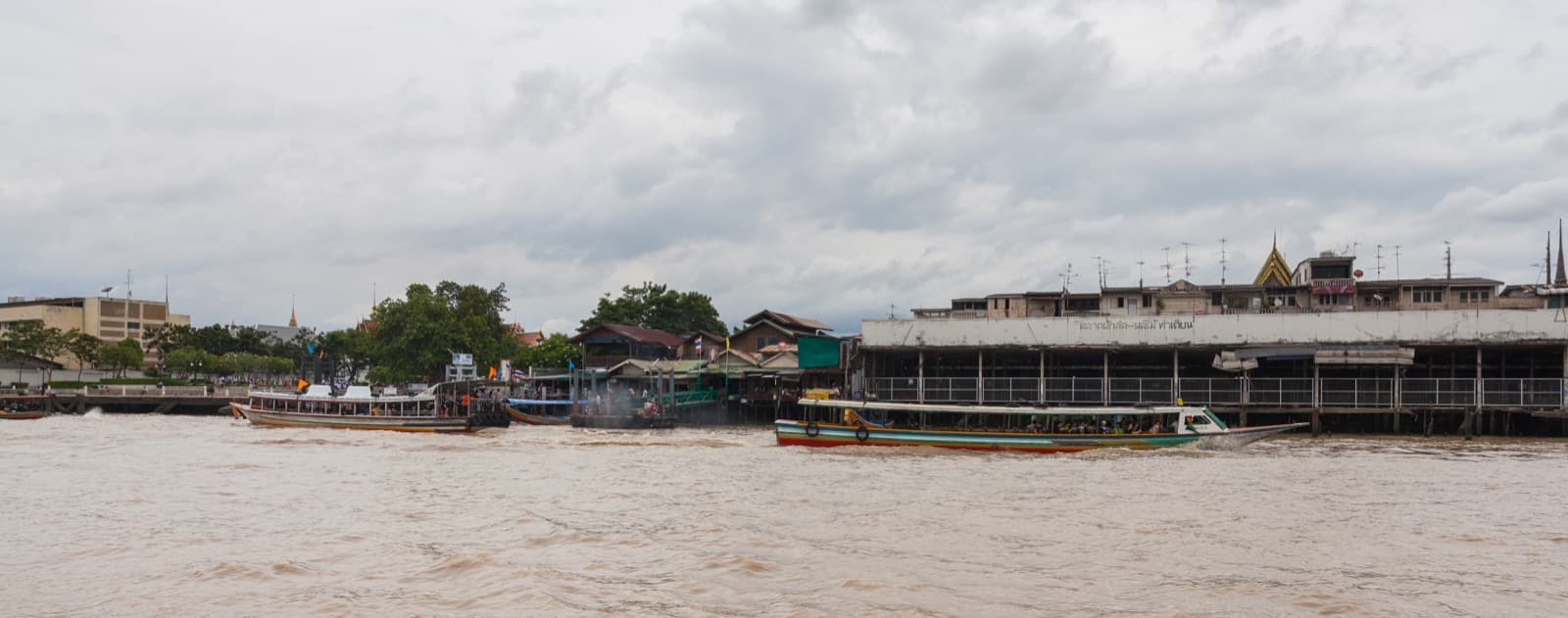 Boats and riverside views along the Chao Phraya River in Bangkok
